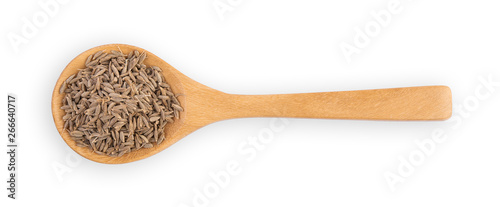 dried caraway seeds in the wooden spoon, isolated on white, top view