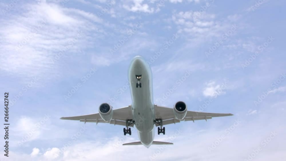 Big jet plane on blue cloudy sky background. Vancouver International Airport in the busy afternoon. Big jet plane on blue cloudy sky background. Vancouver International Airport in the busy afternoon.