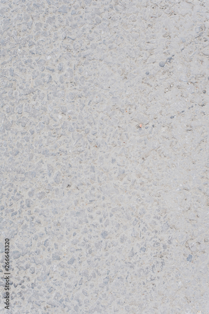 Fototapeta premium The texture of light asphalt. Stone gray background. Vertical photo