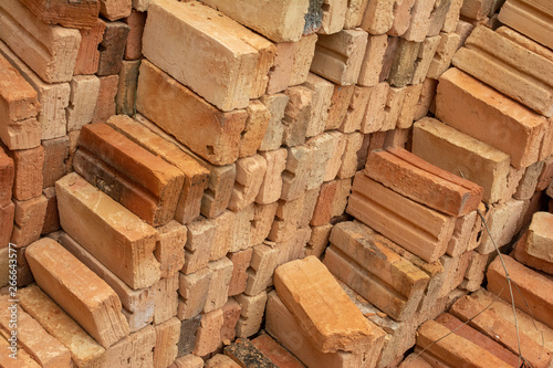 pile of bricks which is prepared for construction. red brick wall at the construction site.