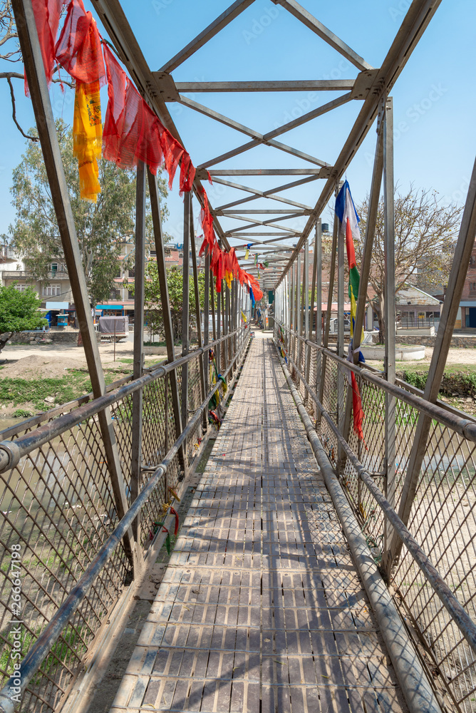 The local small metal bridge for cross bagmati river near Guhyeshwari Temple, Nepal The local small metal bridge for cross bagmati river near Guhyeshwari Temple, Nepal