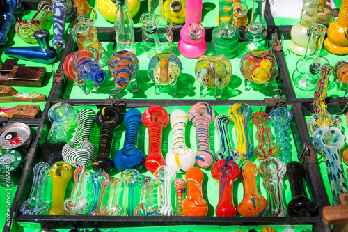 фотографія Various types of glass smoking pipes for marijuana for sale.