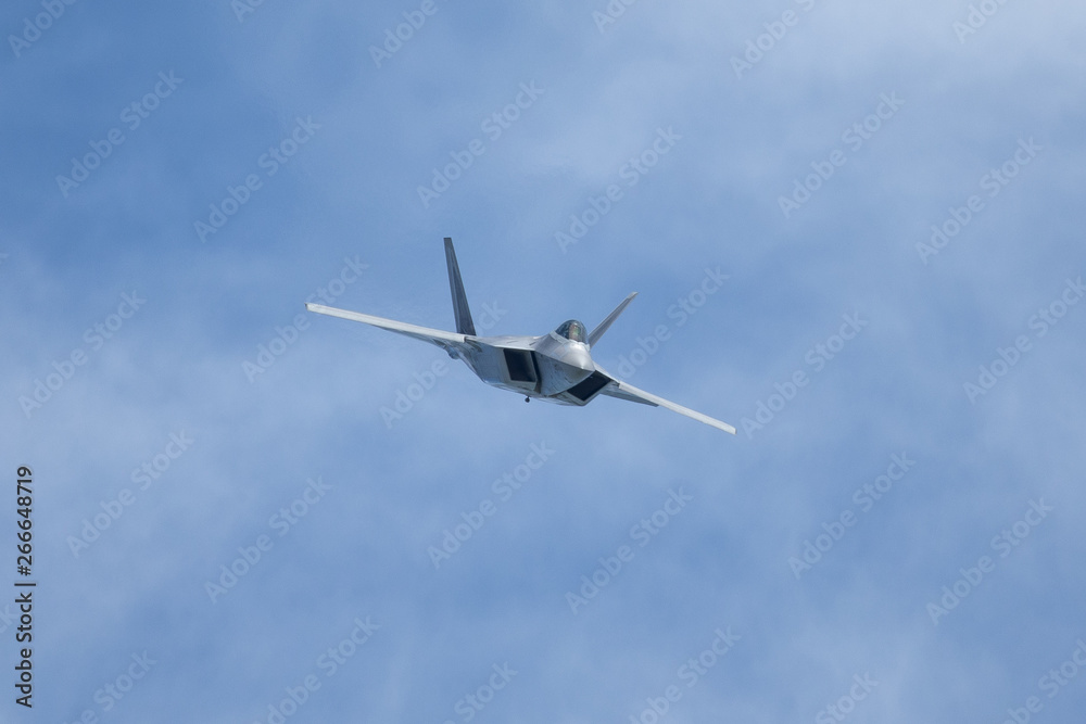 Unusual frontal view of a F-22 Raptor against clouds