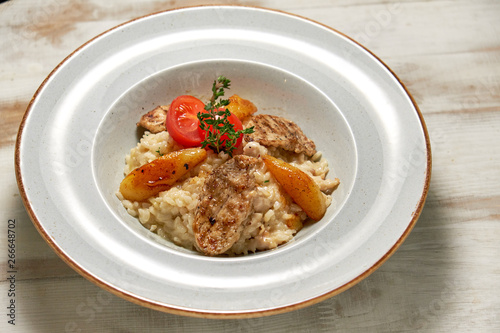 Grilled chicken with white rice. Light wooden background. Restaurant menu