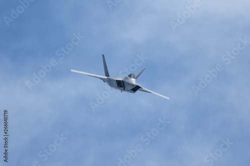 Unusual frontal view of a F-22 Raptor against clouds