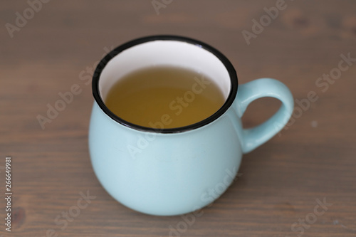 A cup of green tea on a coffee table