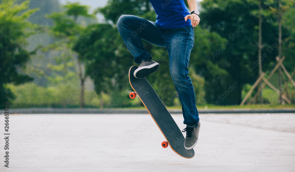 Skateboarder skateboarding on parking lot Skateboarder skateboarding on parking lot