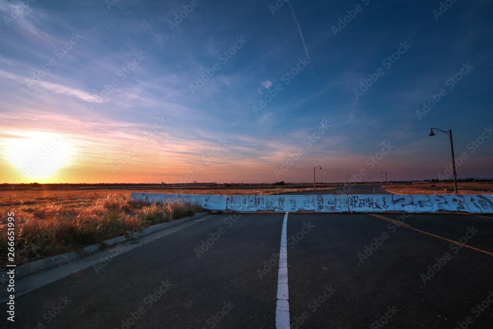 Sun setting on a deserted road