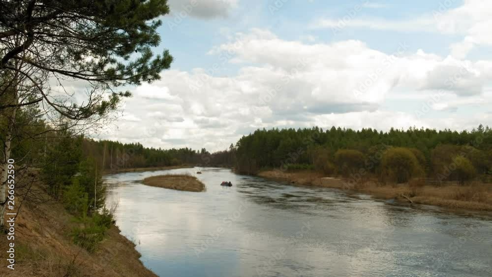 People paddle along the river in cloudy weather. People paddle along the river in cloudy weather.