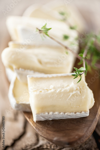 Bild auf Leinwand Organic homemade white brie cheese with pink grapes on a wooden Board