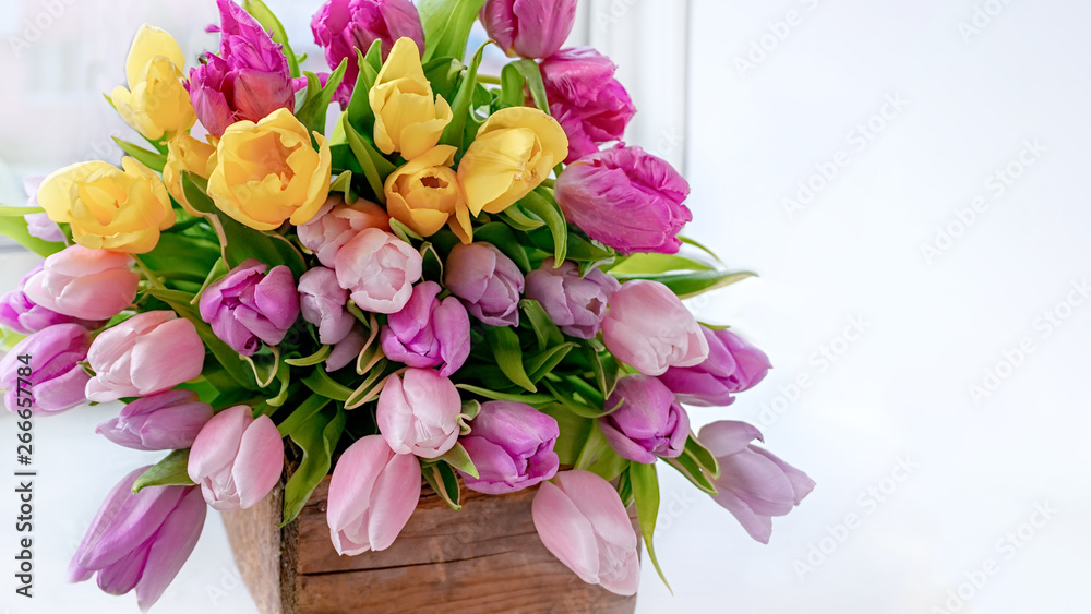 A beautiful bouquet of tulips with a white cup for tea. A beautiful bouquet of tulips with a white cup for tea.