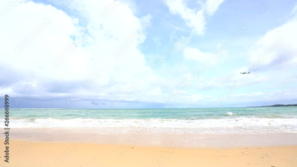 good weather on the beach with small wave and have air plane fly pass there. at Naiyang beach in Phuket good weather on the beach with small wave and have air plane fly pass there. at Naiyang beach in Phuket