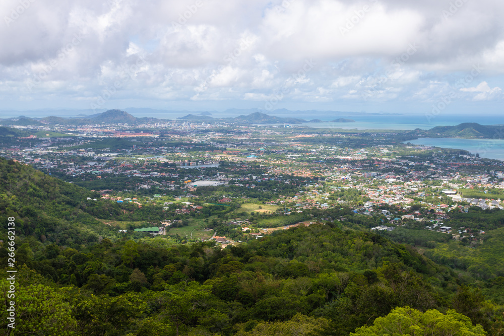 Phuket city scape from high hill ground, can see both town and the beach with cloudy sky