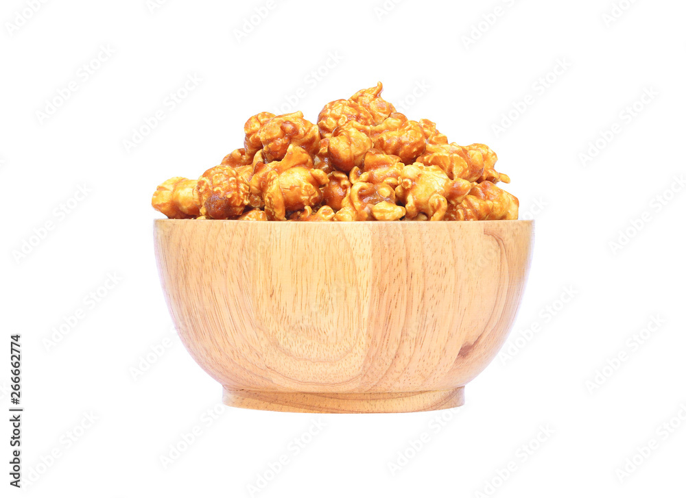 Popcorn with caramel in a wooden bowl isolated on white background with clipping path.. Popcorn with caramel in a wooden bowl isolated on white background with clipping path..