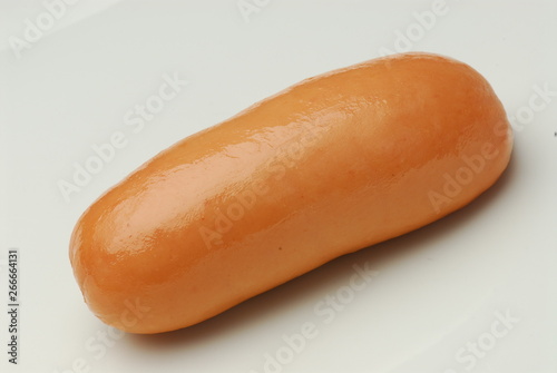 One fresh sausage isolated on gray background