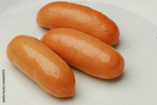 Three fresh sausage isolated on gray background photo