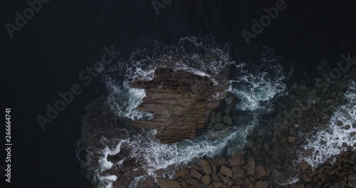 Top down shot of waves crashing on the rocks and beach at Elgol, Isle of Skye in Scotland. photo