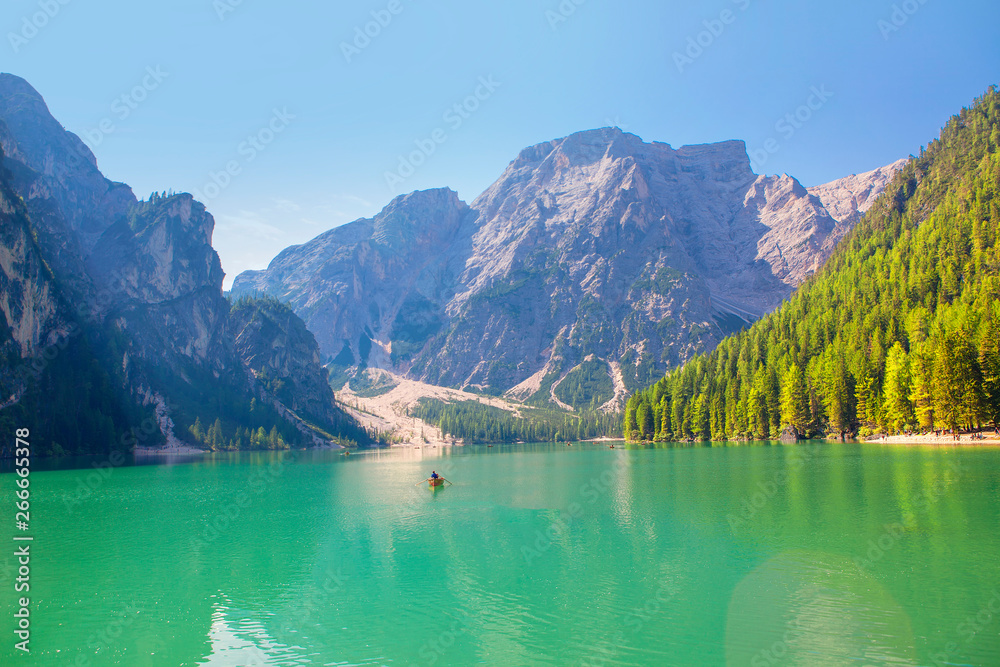 lake is surrounded by mountains and forest 