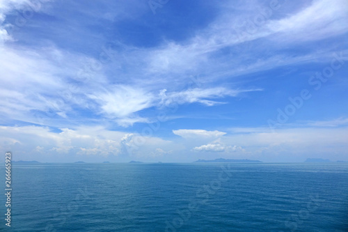 Blue ocean with blue sye and white clouds background. Beautiful seascape
