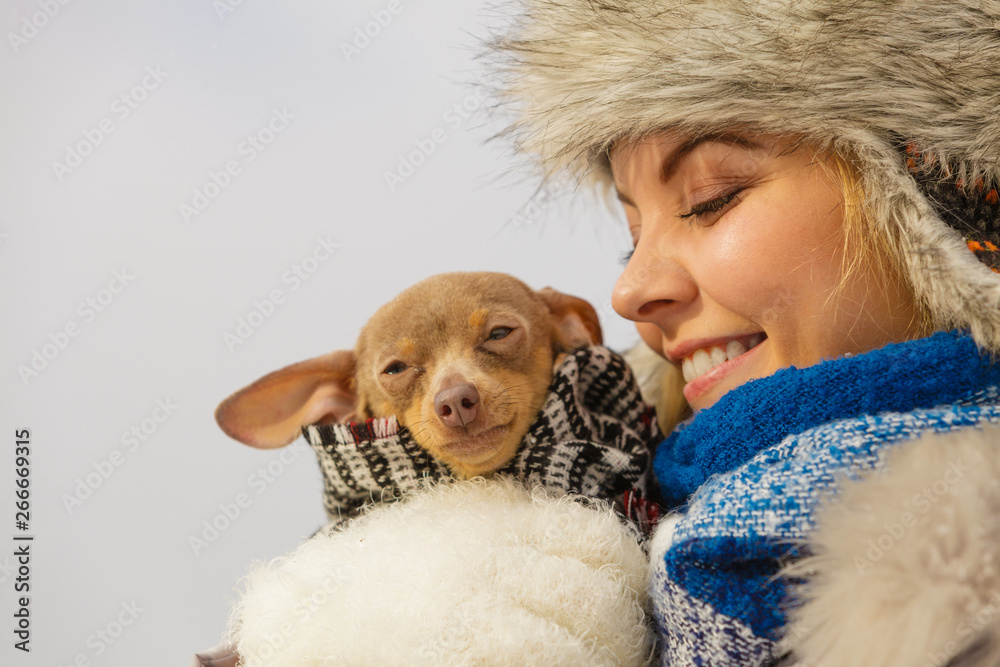 Woman hug warming her dog in cold day Woman hug warming her dog in cold day