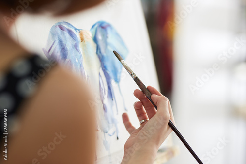 Process of painting picture at the easels in the art studio
