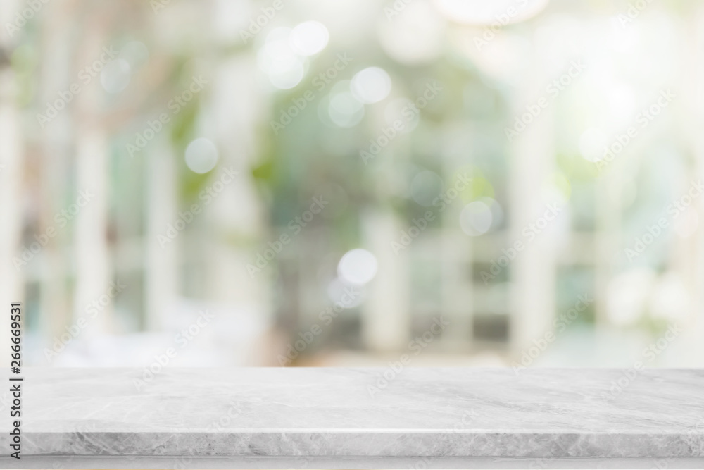 Empty white stone marble table top and blurred of interior room with window view green from tree garden background background - can used for display or montage your products. - obrazy, fototapety, plakaty 