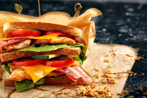 Freshly made clubsandwiches served on a wooden chopping board photo