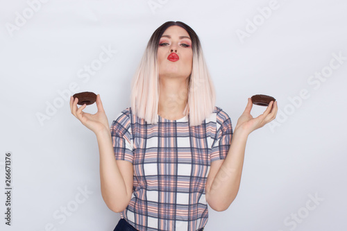 Blond woman holding chocolate donuts