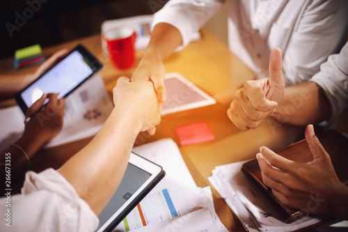 Business people shaking hands, finishing up a meeting Handshake Business concept.vintage color