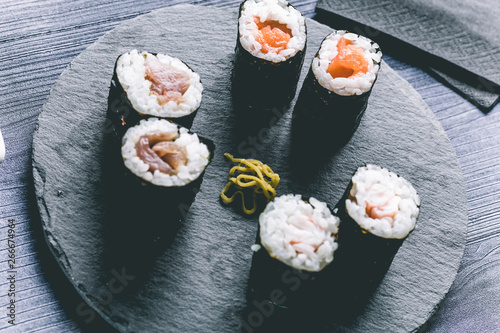 Sushi on wood table. Elegant japanese restaurant. Retro style