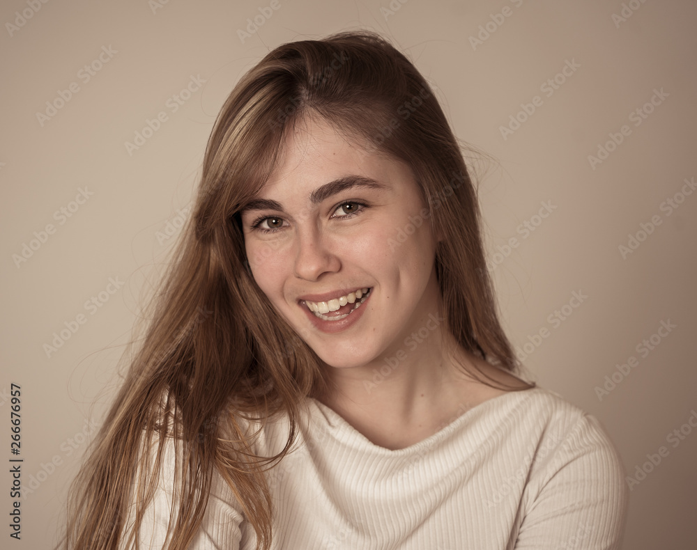 Portrait of young attractive cheerful teenager woman with smiling happy face. Human expressions Portrait of young attractive cheerful teenager woman with smiling happy face. Human expressions