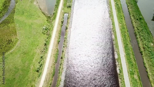 top-down view of the canal and pathway with sunlight shines the water. Shot via Drone photo