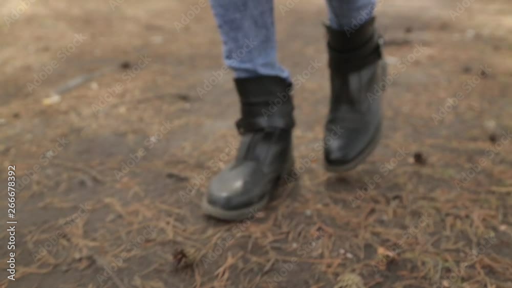 Footsteps on the ground in the woods. Walk in the Park and legs in the frame. Footsteps on the ground in the woods. Walk in the Park and legs in the frame.