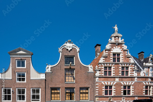 Canvas Print stepped gable of typical dutch houses Hoorn, The Netherlands, against blue sky