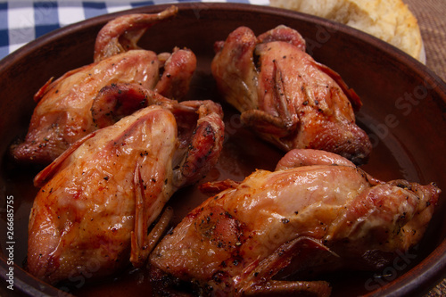 Roasted tiny chicken with Golden brown crispy crust. Close-up.