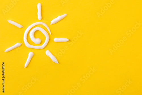 Sun from cream on bright pink background. Sun protection concept. Ultraviolet protection. Summer. Vacation top view photo