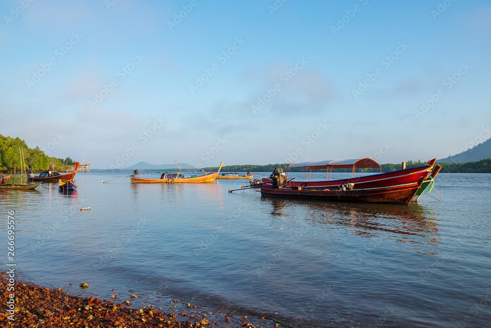 Fisherman Boat in the Morning Light in the Sea