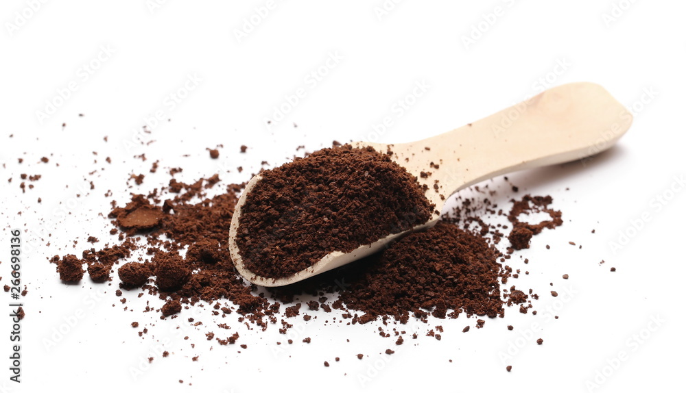 Milled coffee powder for espresso with wooden spoon isolated on white background Milled coffee powder for espresso with wooden spoon isolated on white background