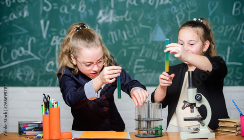 Girls school uniform excited proving their hypothesis. Gymnasium students with in depth study of natural sciences. School project investigation. School experiment. School for gifted children