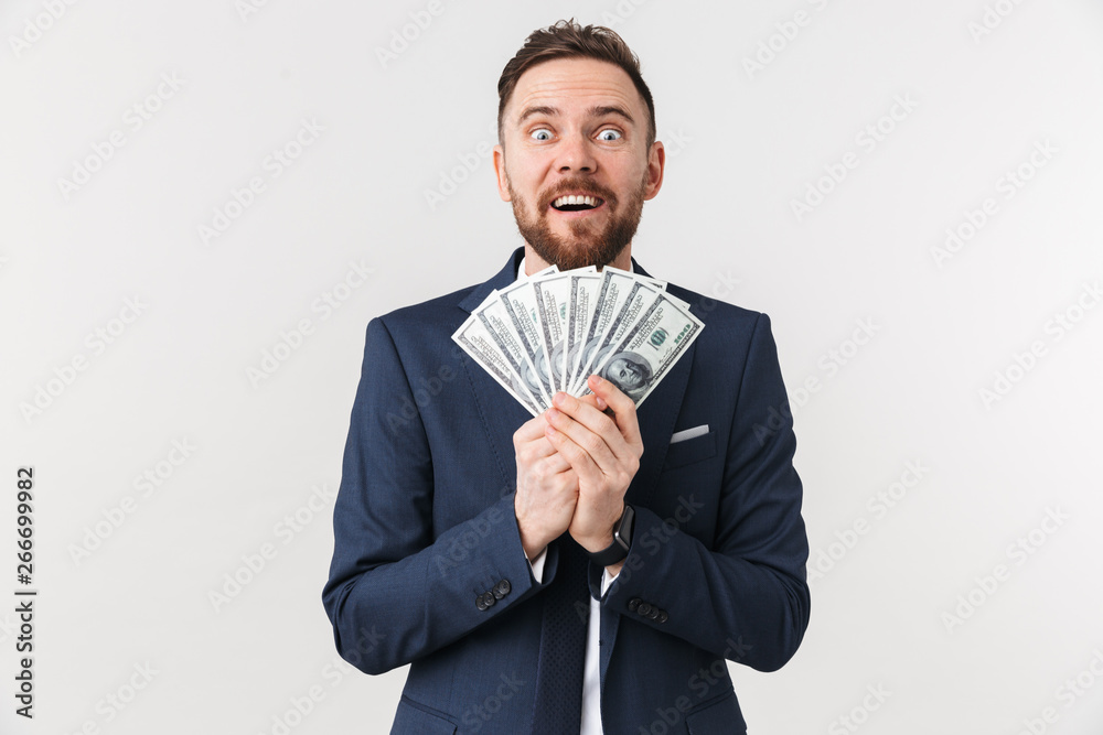 Businessman posing isolated over white wall background with money. Businessman posing isolated over white wall background with money.