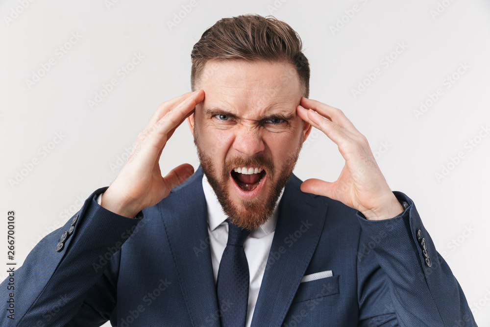 Screaming businessman posing isolated over white wall background. Screaming businessman posing isolated over white wall background.