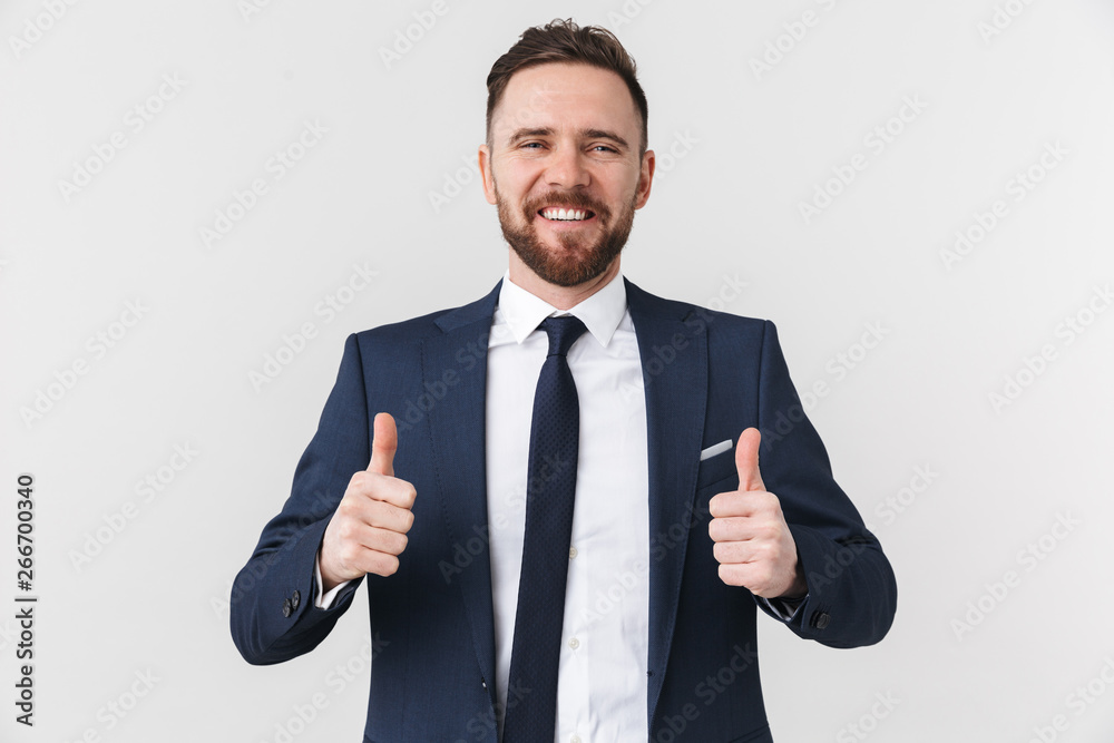 Young businessman posing isolated over white wall background showing thumbs up. Young businessman posing isolated over white wall background showing thumbs up.