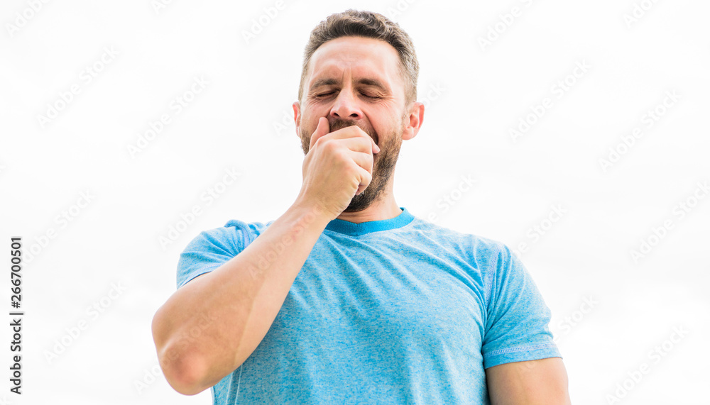 Relaxing after training. man athlete in blue sport tshirt. sportswear  fashion. yawning muscular male with beard. sleepy man isolated on white.  sportsman with athletic body. coach in gym after workout Stock Photo