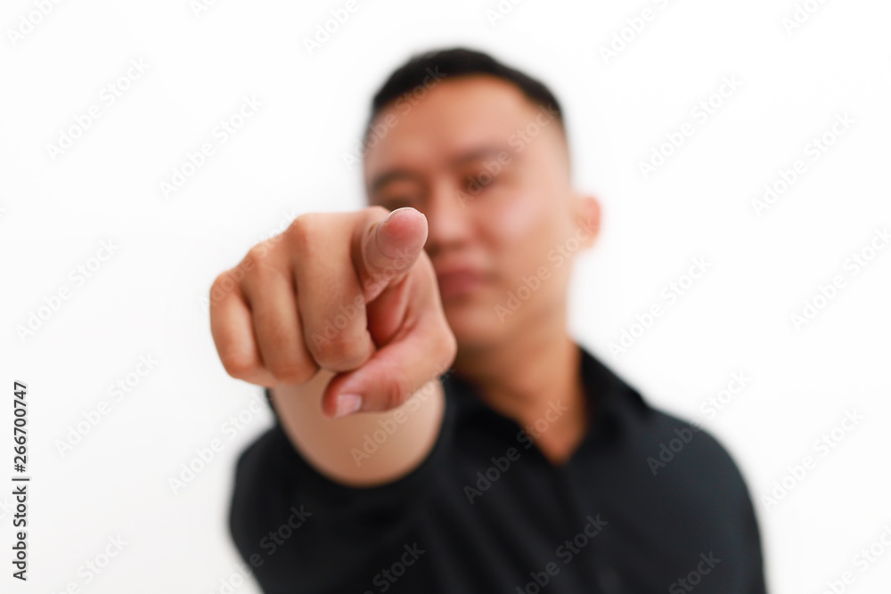 Young asian man pointing to the front with finger, isolated on white background. Young asian man pointing to the front with finger, isolated on white background.