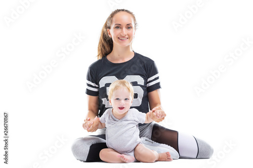 Smiling mother is sitting with happy child at white iosolated background. Concept of happy family.