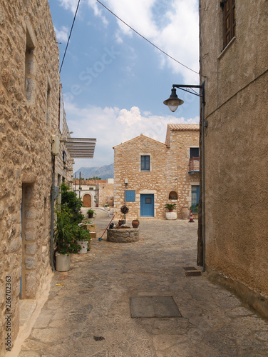 Traditional stone houses village square with water well in Mani, Peloponnese, Greece.