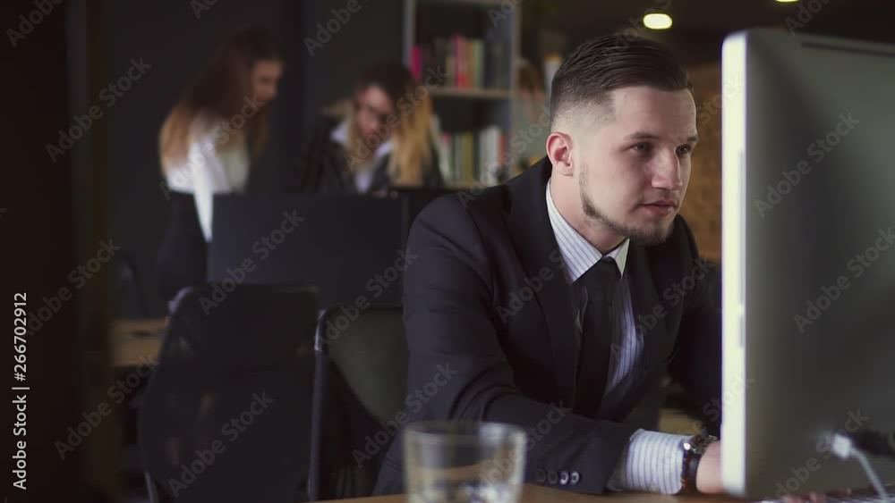 Businessman Working at Computer in Office Businessman Working at Computer in Office