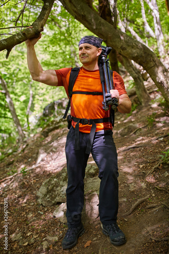 Hiker with camera in the forest