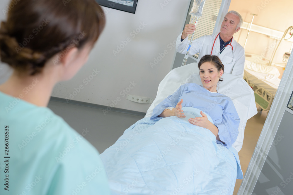 female patient being wheeled in her bed female patient being wheeled in her bed