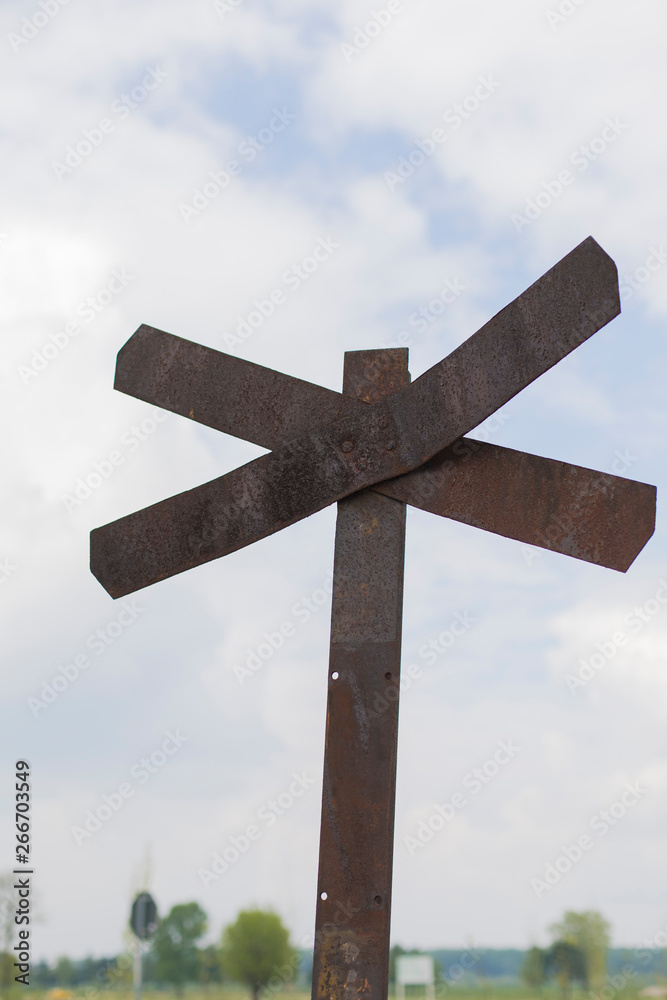 closeup of old rusty railroad crossing sign